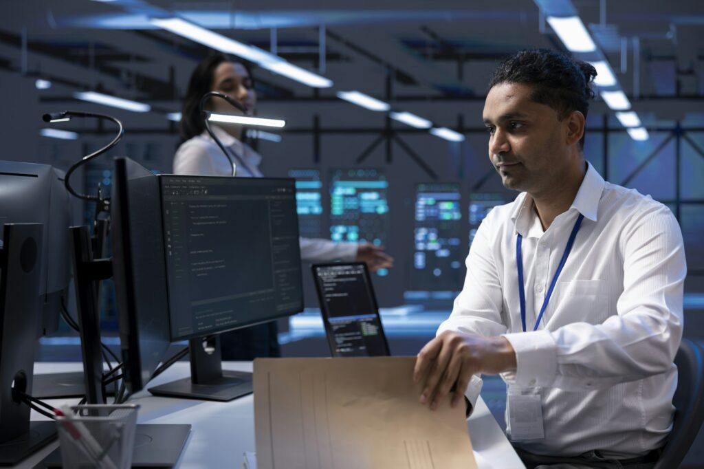 Man in server room ensuring compliance with industry regulations